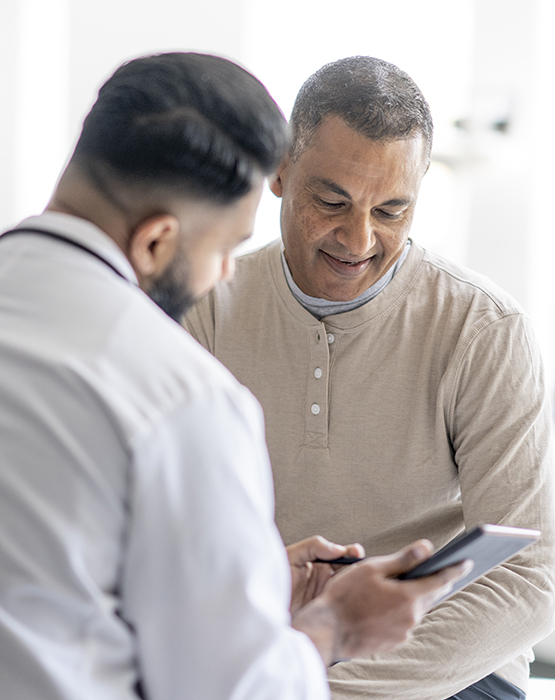 Physician showing information to patient