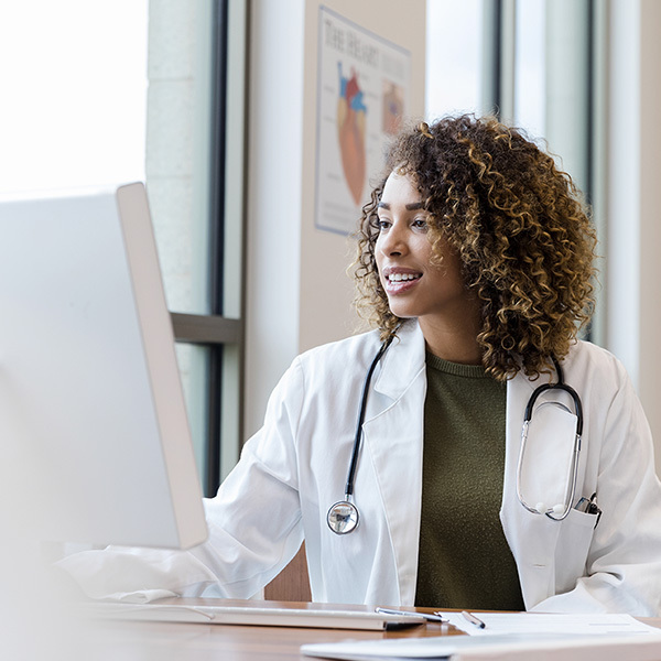 Physician looking at computer