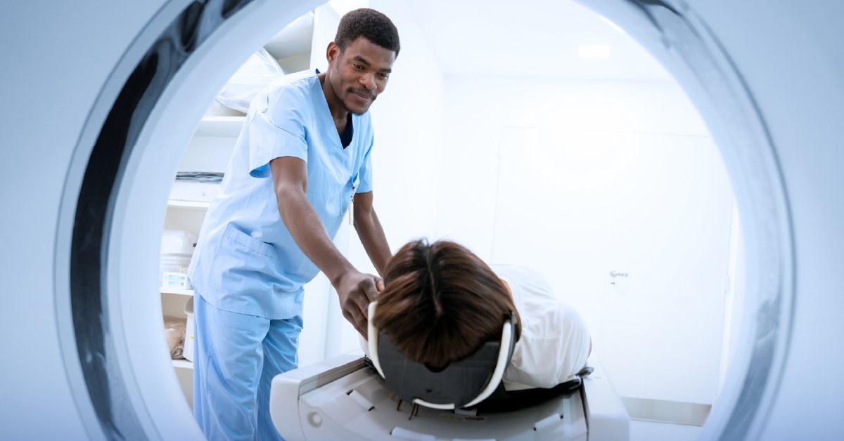 Technician moving patient into MRI machine