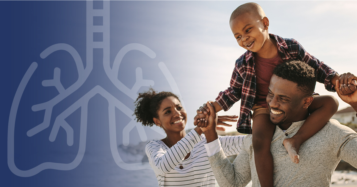 Individual holding child on shoulders smiling